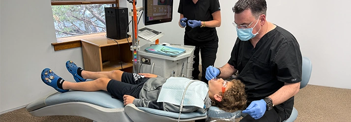 Orthodontist West Chester PA Richard Tanzilli Examining Patient Contact Us Richard Tanzilli Examining Patient
